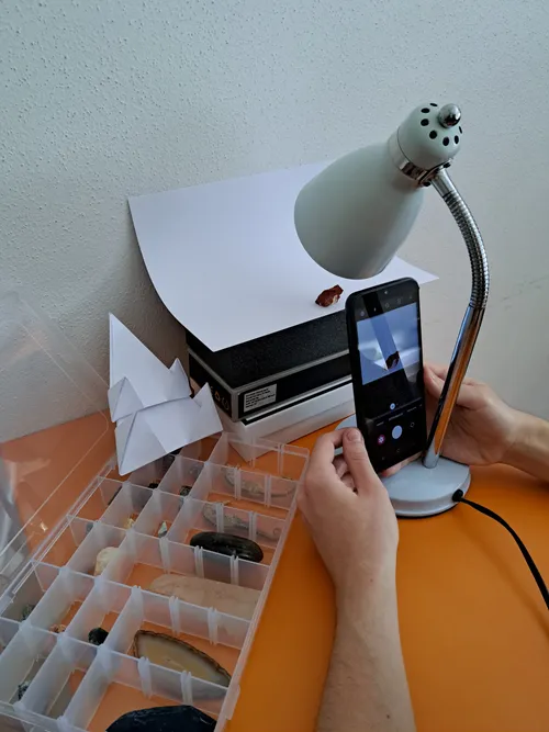 Mineral photo studio with paper, lamp, phone and boxes